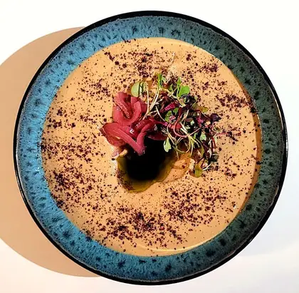 Hummus on a blue bowl