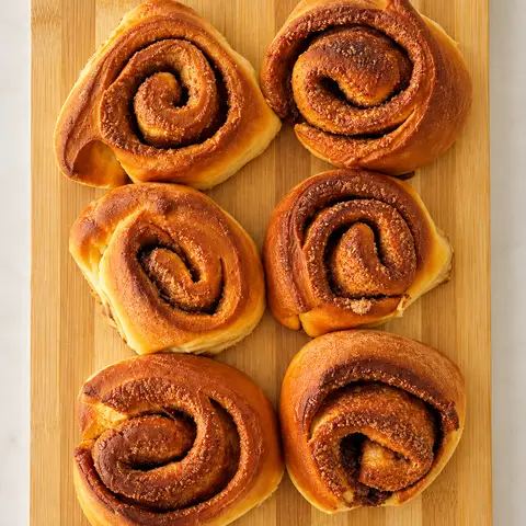 6 cinnamon buns on a wooden board